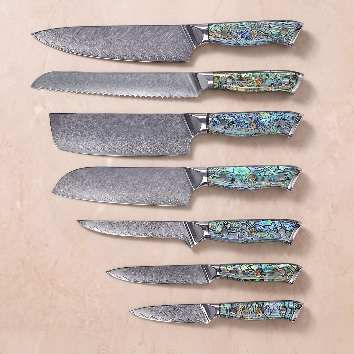 Japanese Damascus Knife Set, 7 Pieces, Galaxy Aurora, all seven knives with abalone shell handles laid out