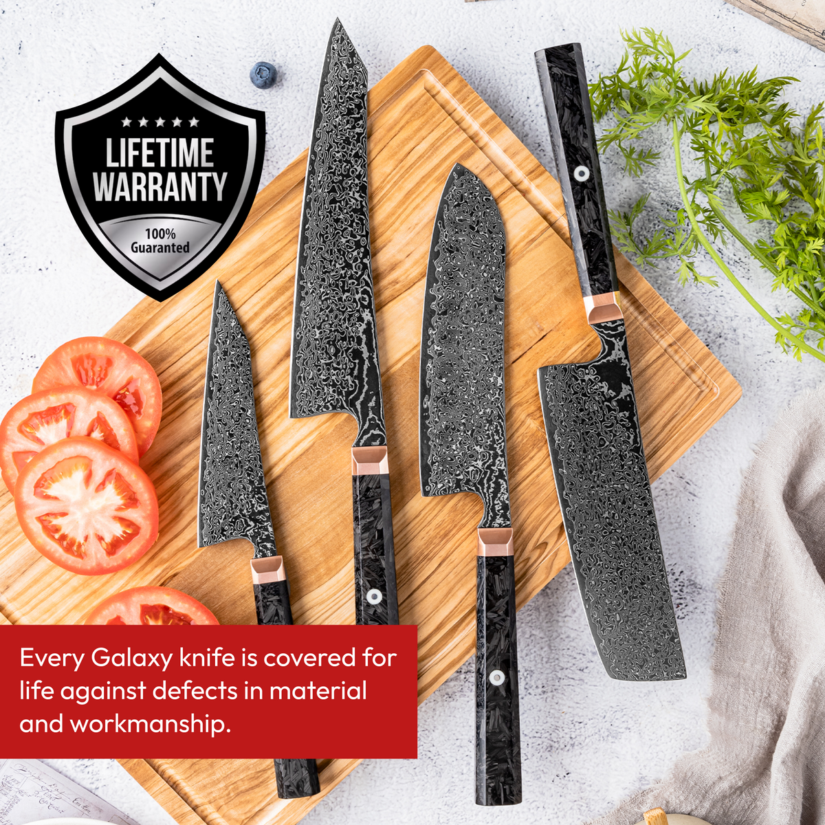 Japanese Damascus Knife Set, 4 Pieces, Galaxy Obsidian, on a cutting board with tomatoes and lifetime warranty badge