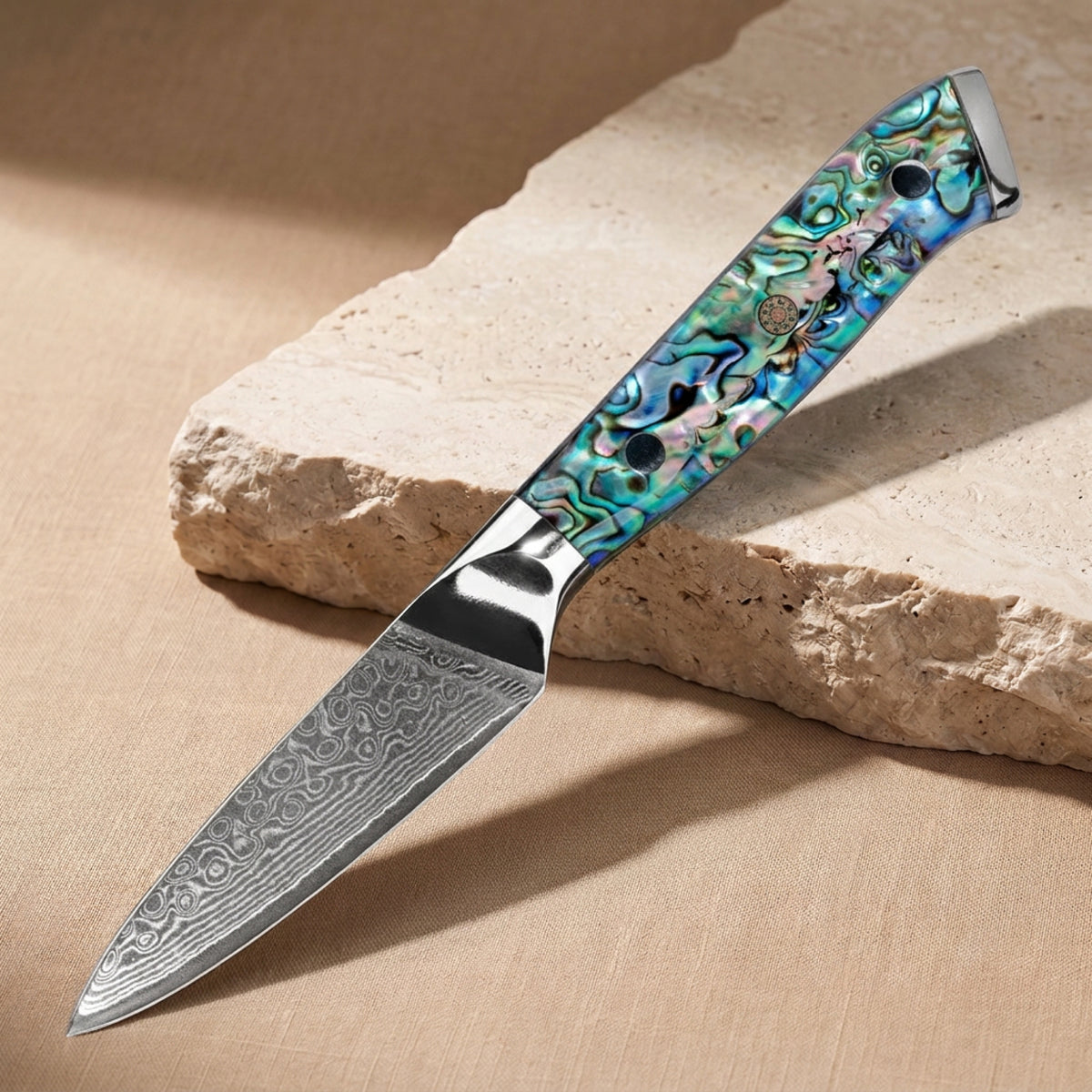 Paring Knife 9 cm, Japanese Damascus steel, Galaxy Aurora, abalone shell handle, on natural stone
