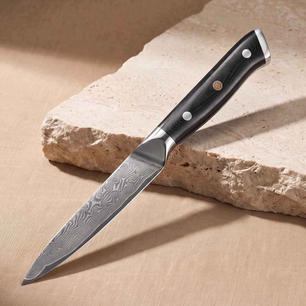 Utility Knife 13 cm, Japanese Damascus steel, Galaxy Orion, black G10 handle with gold pin, on natural stone