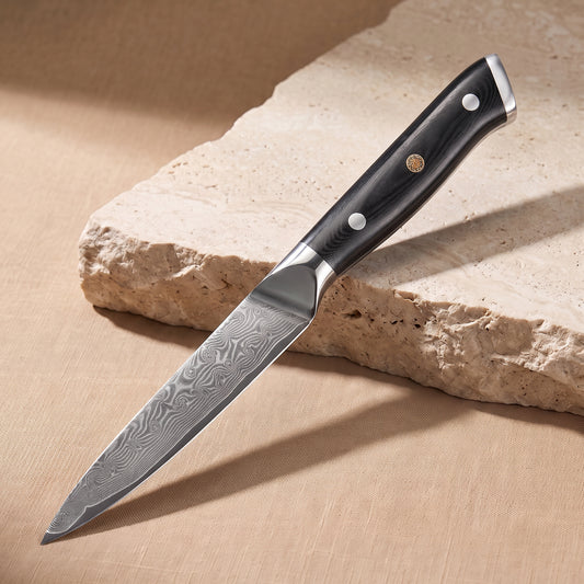 Utility Knife 13 cm, Japanese Damascus steel, Galaxy Orion, black G10 handle with gold pin, on natural stone