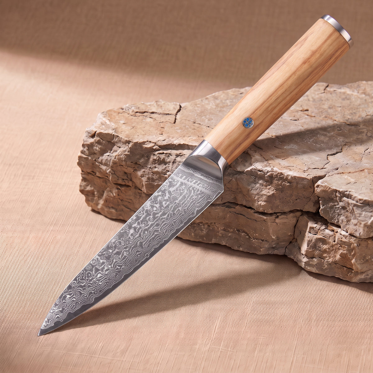 Utility Knife 13 cm, Japanese Damascus steel, Galaxy Takumi, olive wood handle with turquoise pin, on natural stone