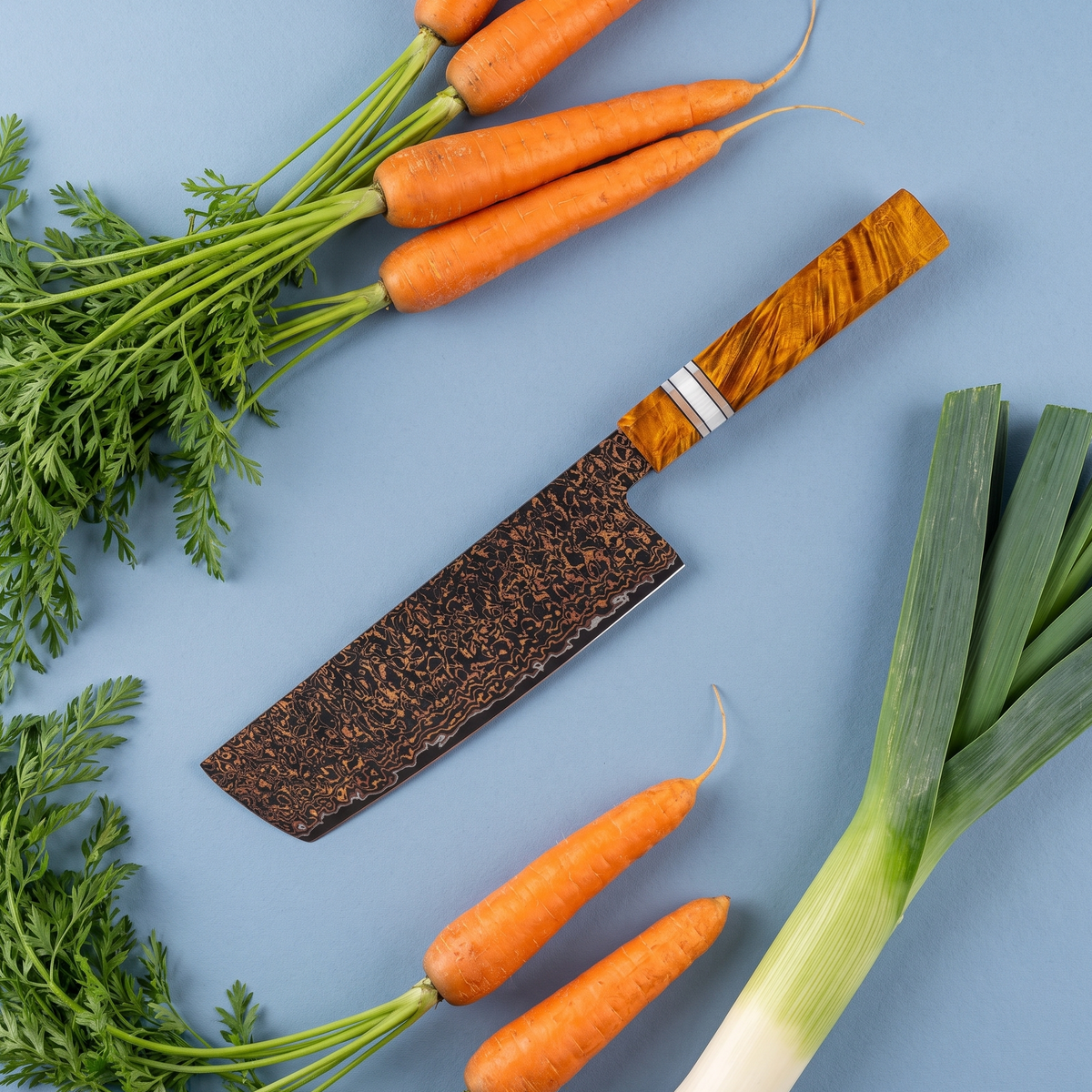 Nakiri Vegetable Knife 18 cm, Galaxy Shinsei, flat lay on light blue with carrots and leek